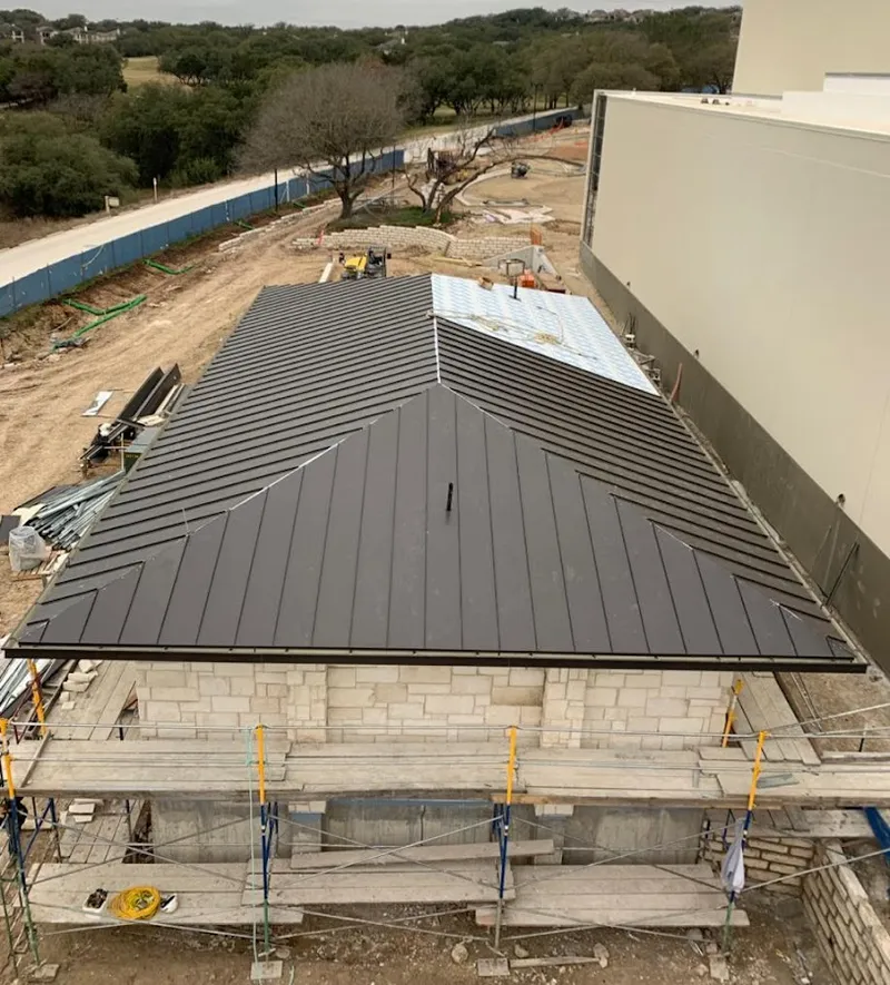 Metal roof new construction with scaffolding in Amherst